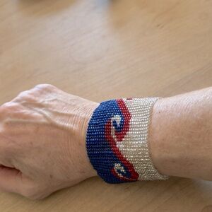 Beaded (non-stretch) bracelet in red, silver, blue, w/ beautiful clasp. New.